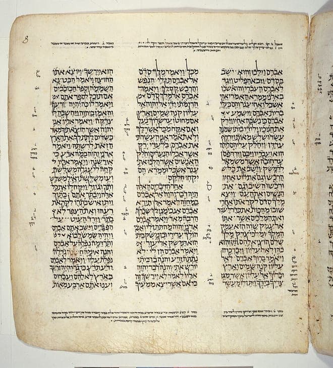 A three-column page of the Leningrad Codex: pointed Hebrew consonantal text with tiny masoretic notes filling the margins between and around the columns.