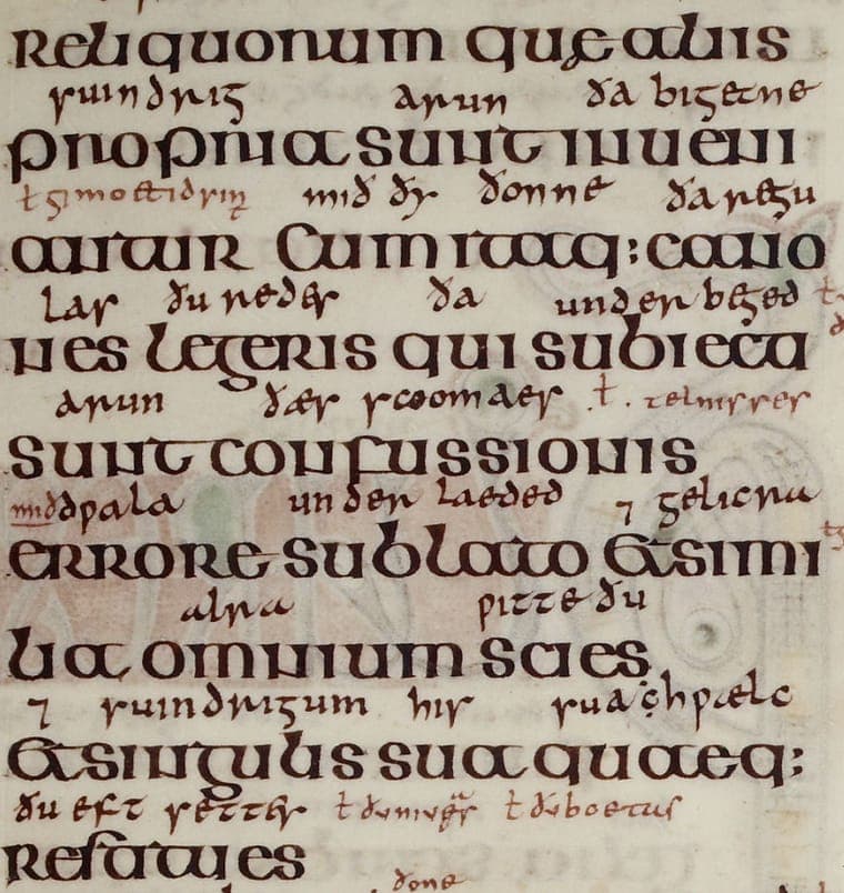 A column of the Lindisfarne Gospels: large Latin letters with a smaller, cramped Old English translation written above every line.