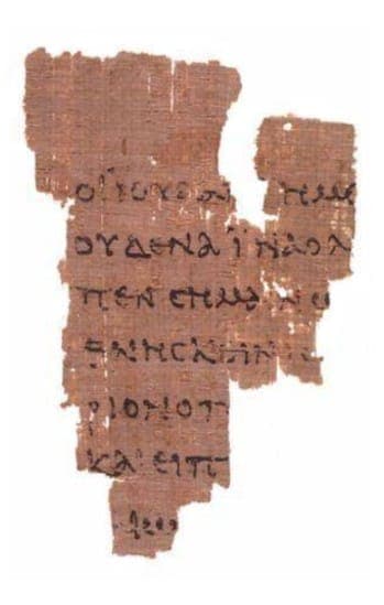 Rylands Papyrus 52: a small, ragged fragment of brown papyrus with a few lines of Greek visible along each broken edge.